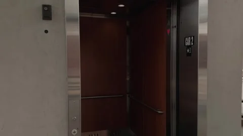 Slow Motion Pan as Elevator Doors Open and Close in Modern Building Vídeos de archivo 327340577