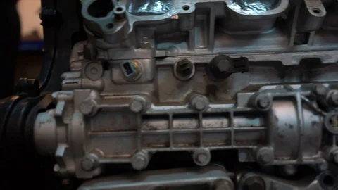 Slow motion pan of engine block side with balance shaft casing in front Stock Footage 99337463