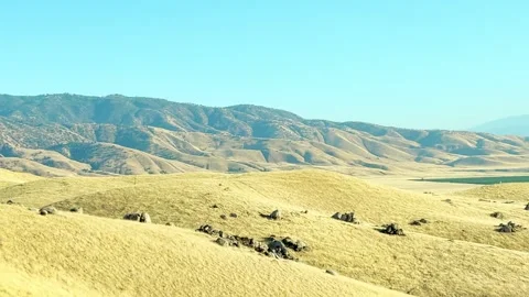 Slow Motion Pan Mountain Hills Valley Yellow Grass Boulders Blue Sky California Stock Footage 344056967