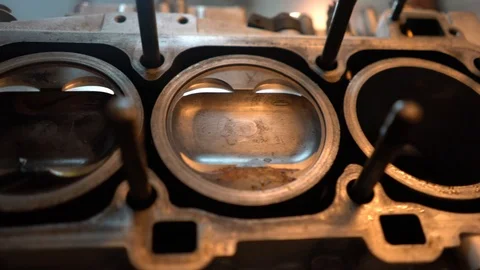 Slow motion pan of open deck engine block. Pistons and cylinder bores visible. Stock Footage 99335166