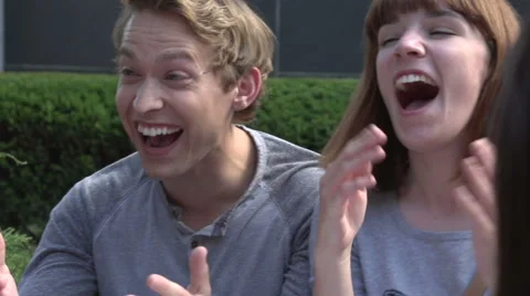 Slow motion pan over three students laughing. Stock Footage 44117347