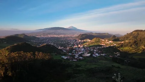 Slow motion pan over valley town and Teide peak, Anaga Rural Park, Tenerife Stock Footage 346472198