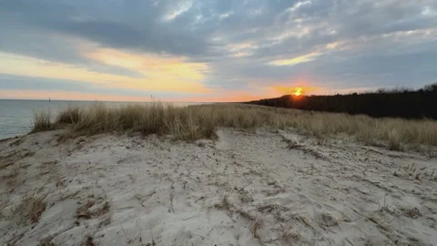 Slow-motion pan shot of sunset over the Baltic Sea beach near Graal-Mritz, .. Video stock 310735164