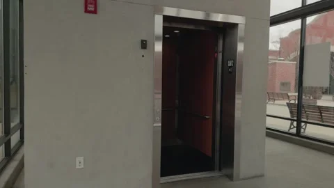 Slow Motion Pan Toward Modern Elevator in Minimalist Building Interior Stock Footage 327340559