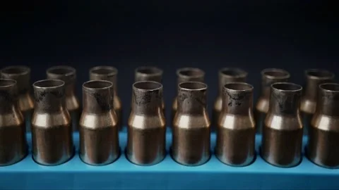 Slow motion pan upwards bullet shells Stock Footage 219387680