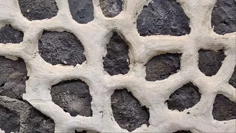 Slow Motion Pan of Volcanic Stone Wall with White Mortar 1080p Video stock 335281449