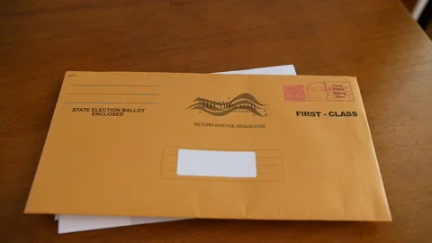 Slow Motion Pan of Vote By Mail Ballot on Table Vidéo 139358968
