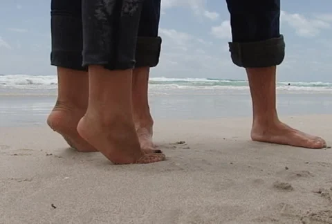 Slow motion pan on young couple at the beach Stock Footage 1065623