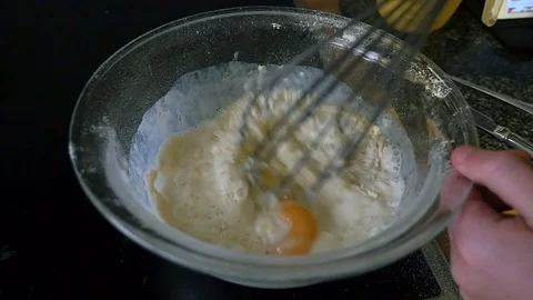 Slow Motion of Pancake batter being whisked in a glass bowl Stock Footage 101284076