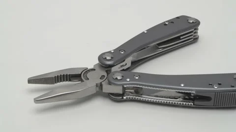 Slow motion panorama of a multitool on a white background. 動画素材 267541316