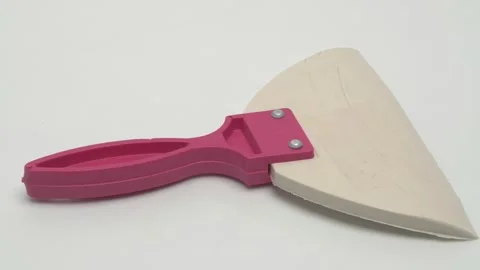 Slow motion panorama of a white rubber spatula on a white background. Видео 267544073