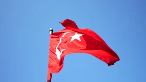 Slow motion panoramic shot of the row of Turkey national flags on high flagpole Stock Footage 280374464