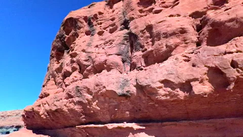 Slow motion panoramic up shot of rugged red boulders and stones with texture Stock Footage 328423714