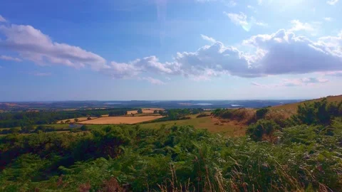 Slow motion panoramic view of countryside valley and blue sky Stock Footage 340436820