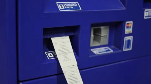 Slow motion of paper receipt printing from blue automated payment terminal Stock Footage 332656020