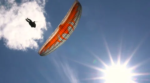 Slow Motion. Paragliding on the Background of the Sun and Beautiful Clouds. Stock Footage 64740100