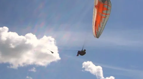 Slow Motion. Paragliding on the Background of the Sun and Beautiful Clouds. Stock Footage 64744636