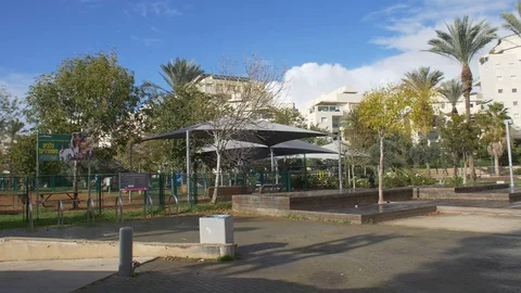 Slow motion of a park and trees with buildings in the background Stock Footage 86650320