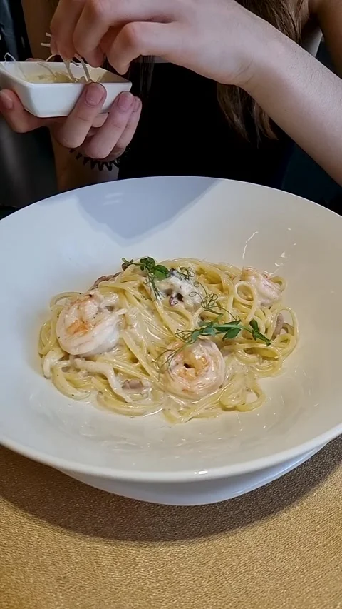 Slow motion parmesan over shrimp pasta vertical Stock Footage 311112412