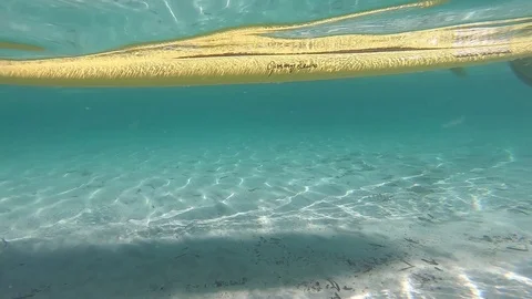 Slow motion passage of a white stand up paddle board filmed from underwater Stock Footage 112067279