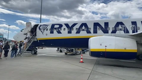 Slow motion of passengers waiting row in front plane RYANAIR boarding Boeing 737 Stock Footage 244947564