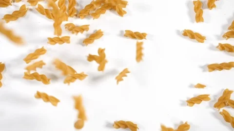 Slow motion pasta of durum wheat dry uncooked cluster fusilli individual  Stock Footage 88341363