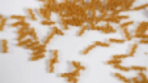 Slow motion pasta of durum wheat dry uncooked cluster shape spirals dropping  Stock Footage 88341502