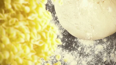 Slow motion pasta falls next to the dough Stock Footage 90959370