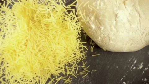 Slow motion pasta falls next to the dough Stock-Footage 90959643