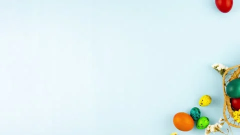 Slow motion on a pastel blue background a wooden wicker basket with a variety of Stock Footage 150377251