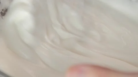 Slow motion pastry chef hand whipping meringue Stock Footage 131054131
