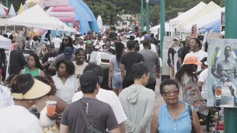 Slow motion patrons coming and going at Atlanta Juneteenth festival Stock Footage 244944838