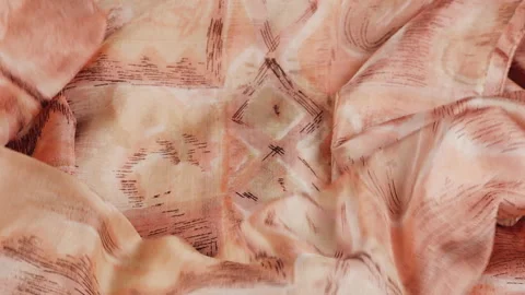 Slow motion of a peach silk fabric falling smoothly onto a white background.  Stock Footage 337404795