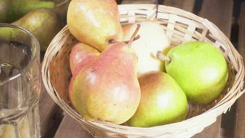 Slow motion pears in a basket and a glass of juice Stock Footage 88216277