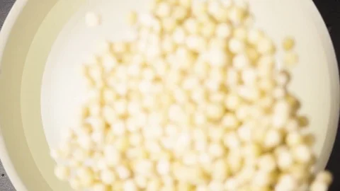 Slow motion peas falls into the water pan Stock Footage 73106738