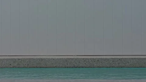 Slow Motion Pebble Concrete Pool Edge White Fence Still Blue Water Stock Footage 304092071