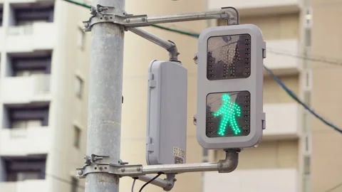 Slow motion of pedestrian lights turning from red to green on red wall building Stock Footage 321144442