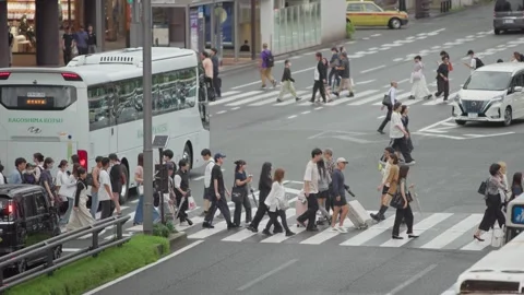 Slow motion of pedestrians crossing large city intersection near Hakata Station Stock Footage 342811074
