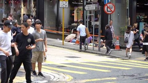 Slow motion of Pedestrians walking over the street in Hong Kong Video stock 124988336