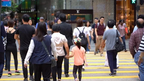 Slow motion of Pedestrians walking over the street in Hong Kong Stock Footage 124988420