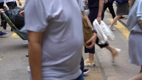 Slow motion of Pedestrians walking over the street in Hong Kong Stock Footage 124988456