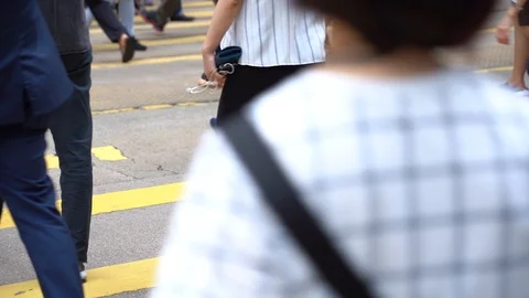 Slow motion of Pedestrians walking over the street in Hong Kong Stock Footage 124988517