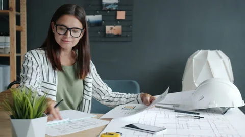 Slow motion of pensive architect studying construction plans working in office Video stock 158095666