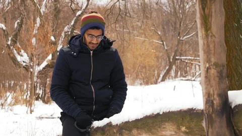 Slow Motion, Pensive Indian Man Rides on Old Swing in Winter in the Forest Stock Footage 101407600