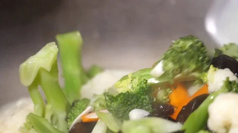 Slow motion of people cooking vegetable with steam on frying pan Stock Footage 79176369