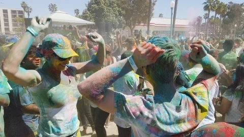 Slow motion of people dancing outside on a festival, color holi festival Stock Footage 135316242