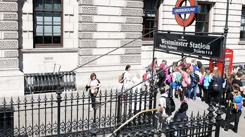 Slow motion of people entering Westminster tube underground station London Stock Footage 108602049