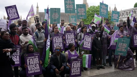 In Slow Motion People Hold Up Placards That Read “I Support The Fair Visa Stock Footage 338052969