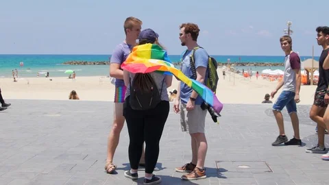 Slow Motion, People with rainbow flag on during Annual Gay Pride Parade, Tel Avi Stock Footage 111032822