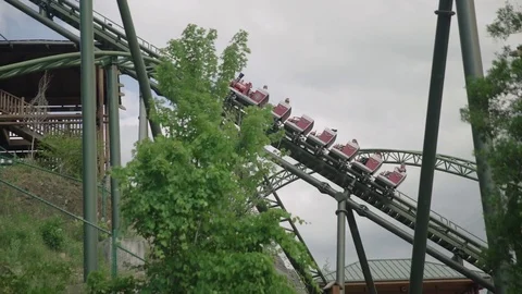 SLOW MOTION: People riding the roller coaster 4k Stock Footage 76512519